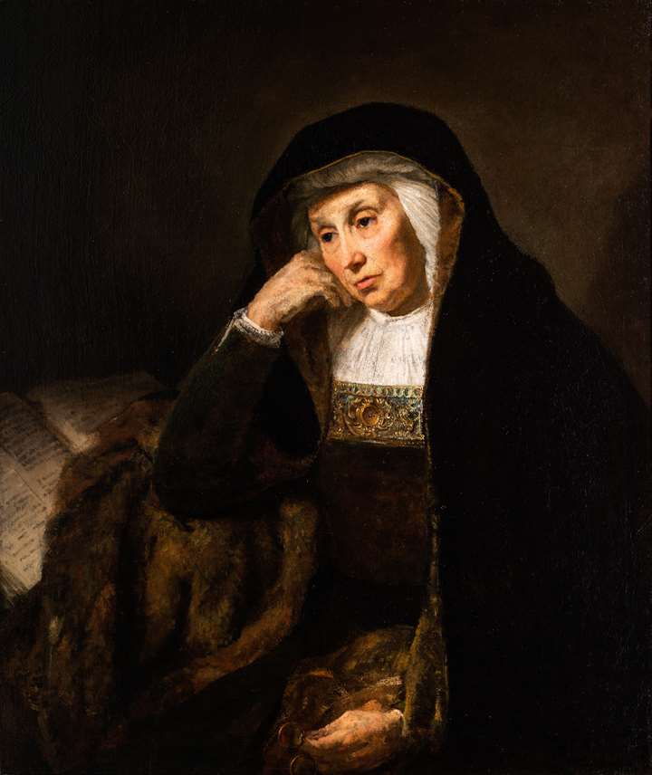 An Old Woman reading at a table.